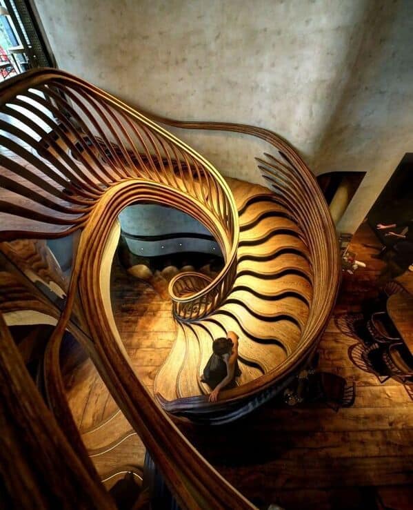 this amazing woodworking photo, a spiral staircase looks like melting wood layers