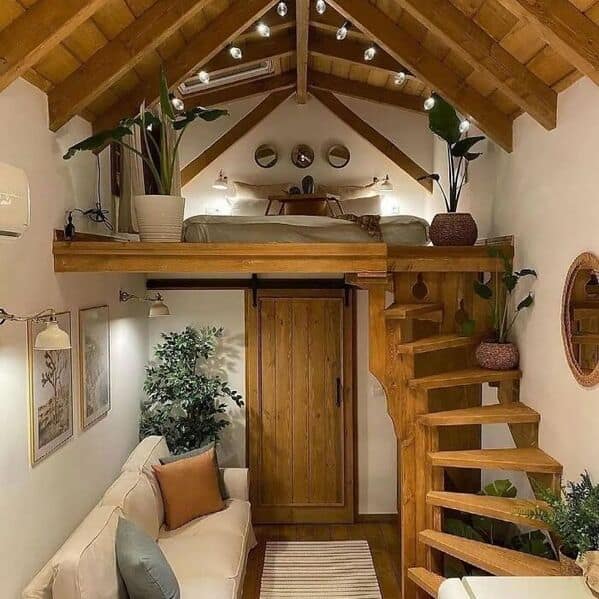 This amazing woodworking loft bed features a rustic spiral staircase and exposed beams