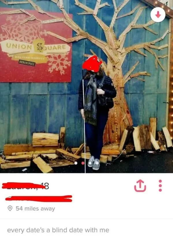 Woman holding white cane standing in front of tree with blind date joke.