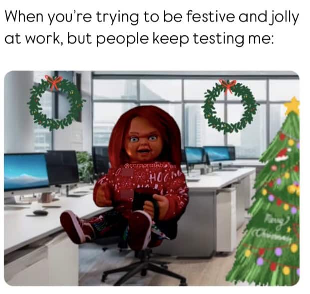 In this christmas meme, Chucky sits in an office trying to be jolly.