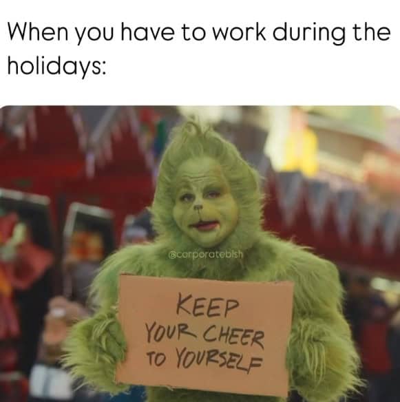 In this christmas meme, the Grinch holds a sign telling people to keep their cheer to themselves.