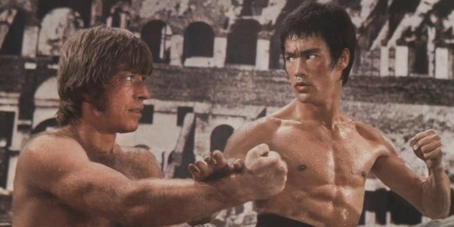 A movie still of Chuck Norris fighting Bruce Lee in The Way of the Dragon.