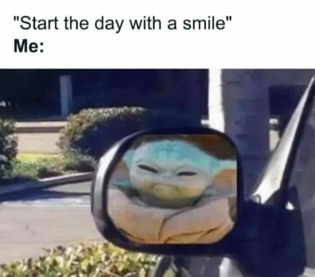 A classic meme of Baby Yoda looking grumpy in a car mirror.
