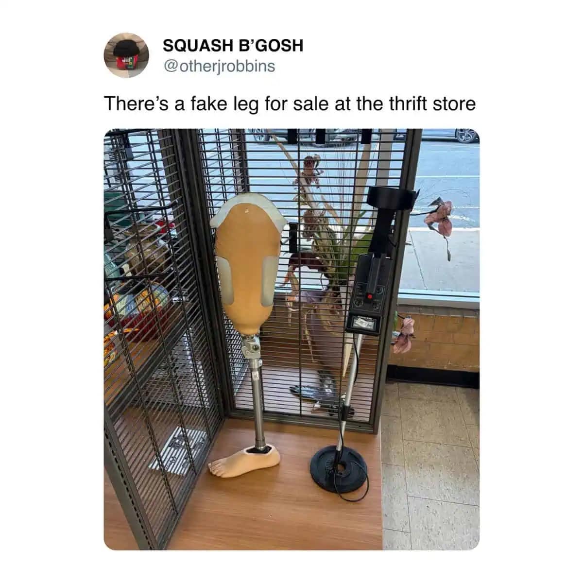 A funny photo of a prosthetic leg standing next to a metal detector at a thrift store.
