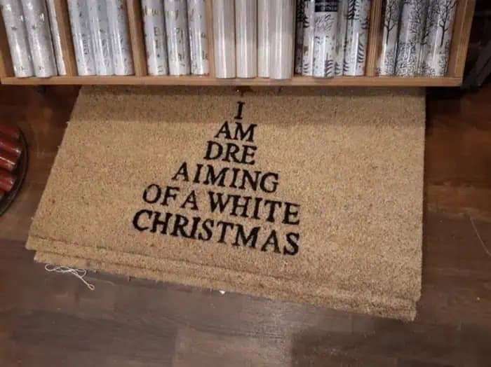 A funny design fail doormat that reads I Am Dre Aiming Of A White Christmas.