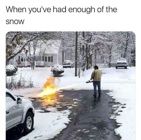 A classic meme showing a man using a flamethrower to clear snow from a driveway.