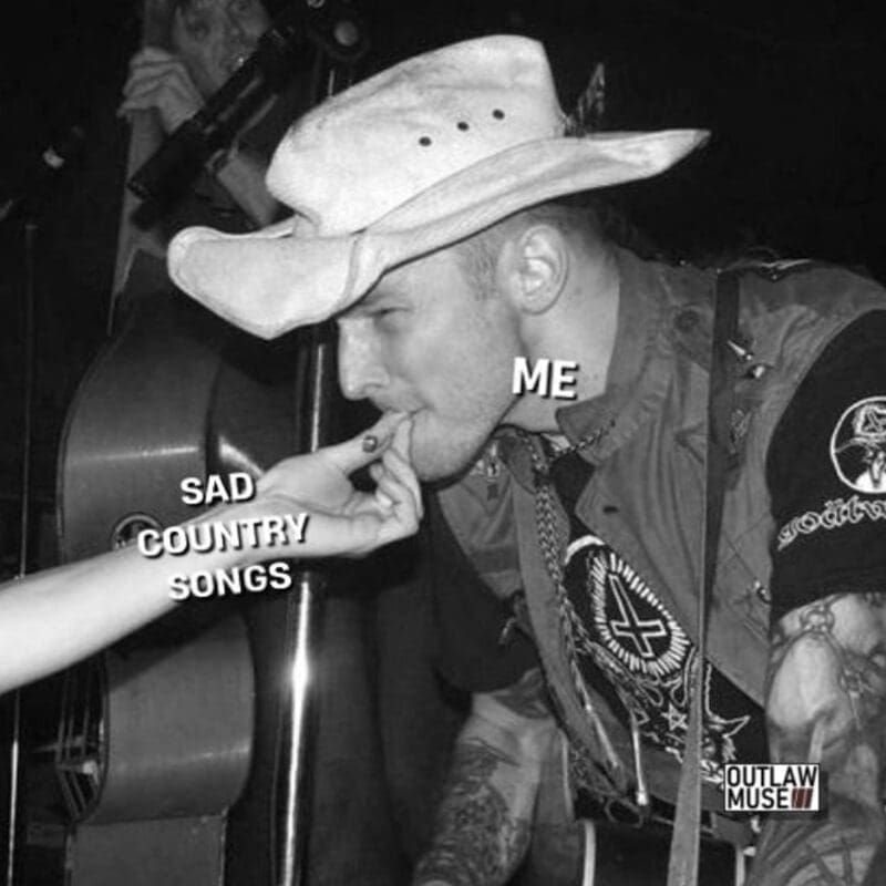 A country music meme showing a metalhead enjoying a light from sad country songs.