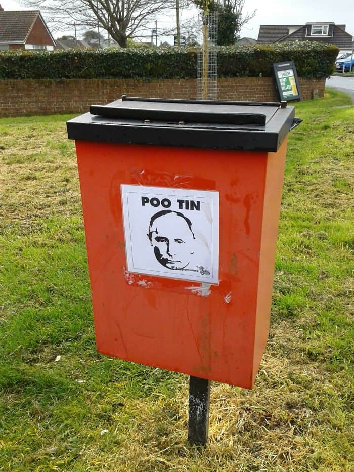 A creative vandalism sticker on a trash can labeling Vladimir Putin as "Poo Tin".