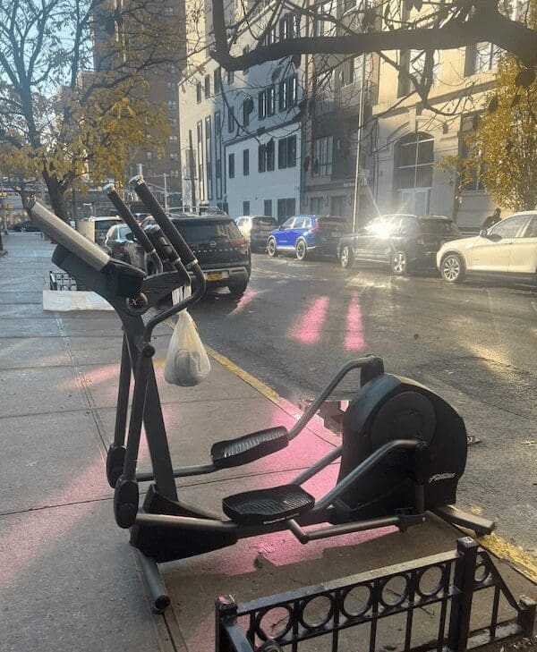 A funny curb find of an elliptical machine abandoned on the street.