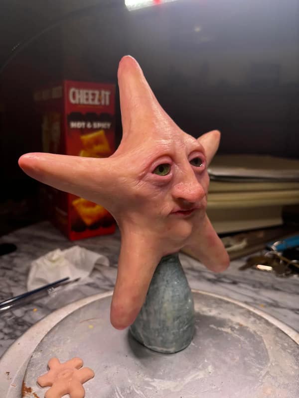 Realistic sculpture of Patrick Star with human eyes used as a cursed image