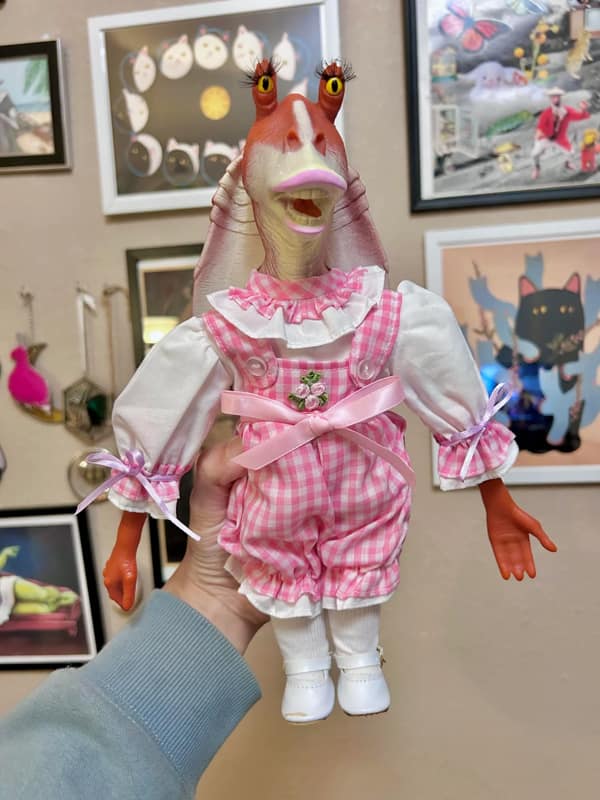 Jar Jar Binks head on a porcelain doll body used as a cursed image. Description: Star Wars merchandise has officially gone too far. This Jar Jar Binks custom doll looks like it comes to life at night to steal your soul. A truly cursed image for the collectors. Is Jar Jar Binks actually the Sith Lord or just the worst character in history?