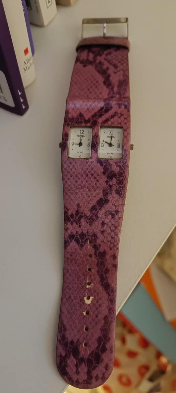 Long snakeskin watch with two vertical faces used as a cursed image.
