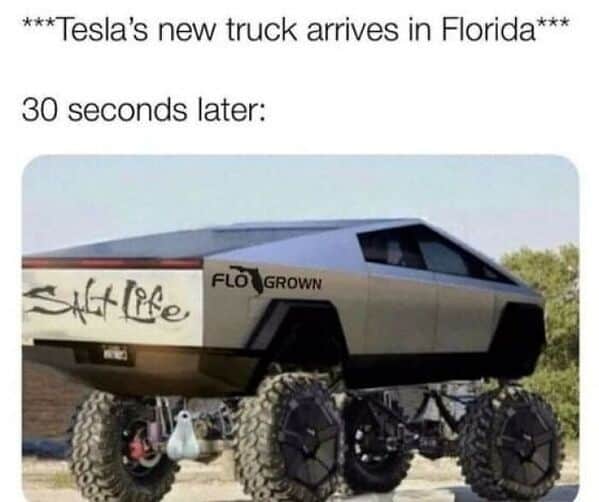 Photoshopped Cybertruck with lift kit truck nuts and Florida themed bumper stickers.