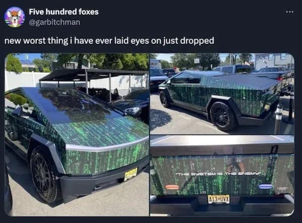 Cybertruck wrapped in green Matrix code with text saying the system is the enemy.