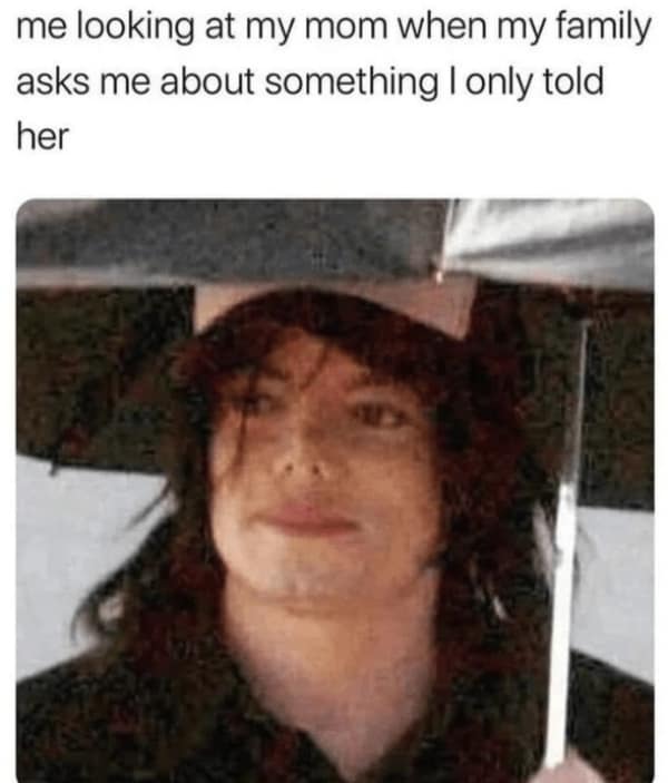 Michael Jackson under an umbrella giving a side eye to his mother.