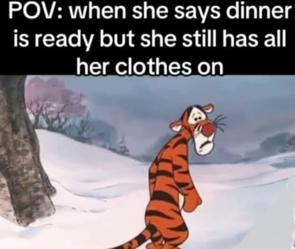 Sad Tigger from Winnie the Pooh walking with head down in snow.