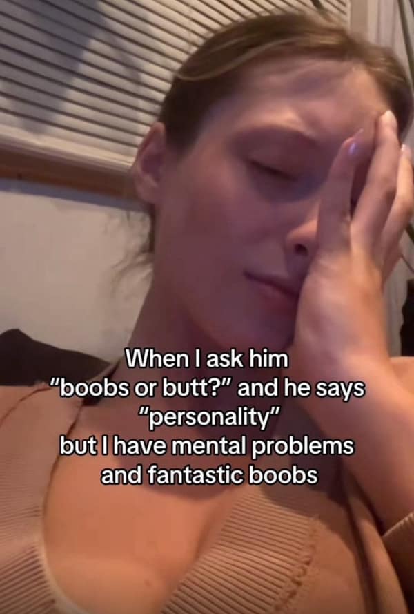 Woman with hand over face looking stressed about personality compliment.