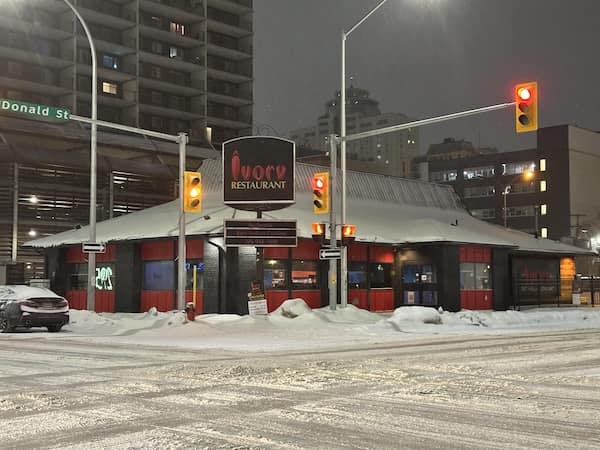 Ivory Restaurant with red and black exterior in a snow covered former Pizza Hut.