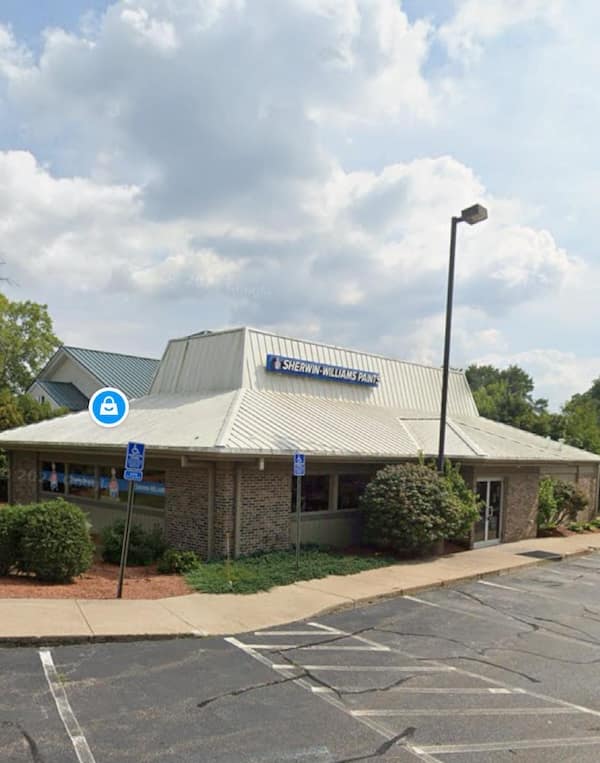 Sherwin Williams paint store inside a white roofed former Pizza Hut building.