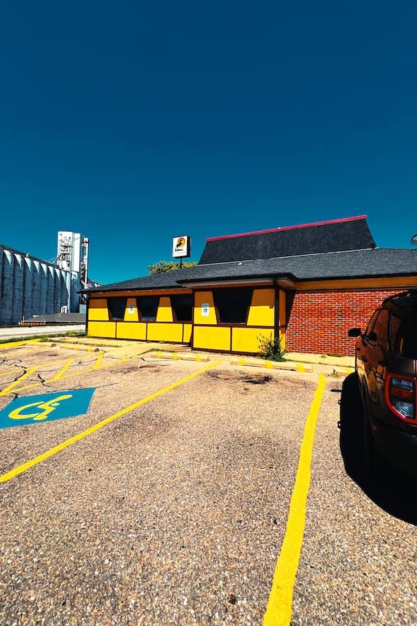 ellow and black painted building with trapezoid windows in a former Pizza Hut.