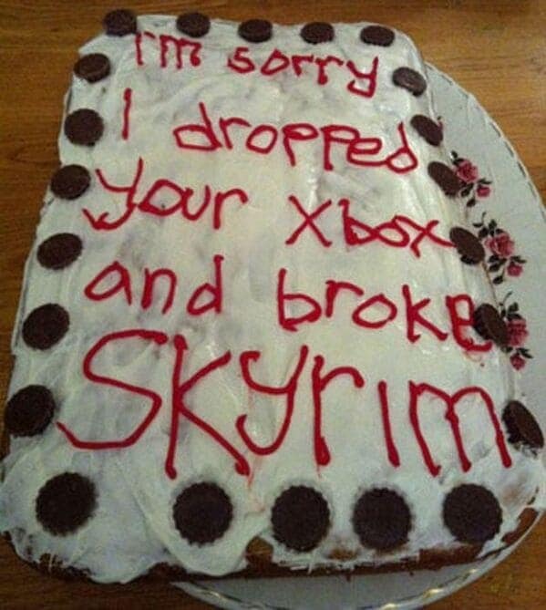 Messy white cake text apologizing for dropping Xbox and breaking Skyrim.