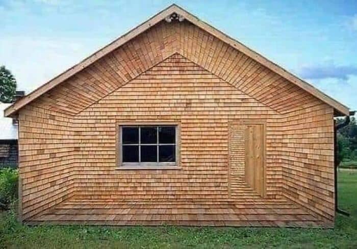 A funny optical illusion of a wooden shed with a camouflaged door.