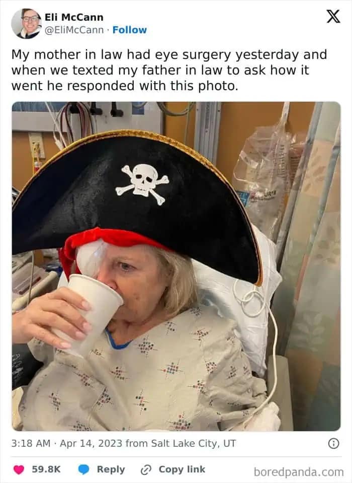 Woman recovering from eye surgery wearing eye patch and pirate hat while drinking.