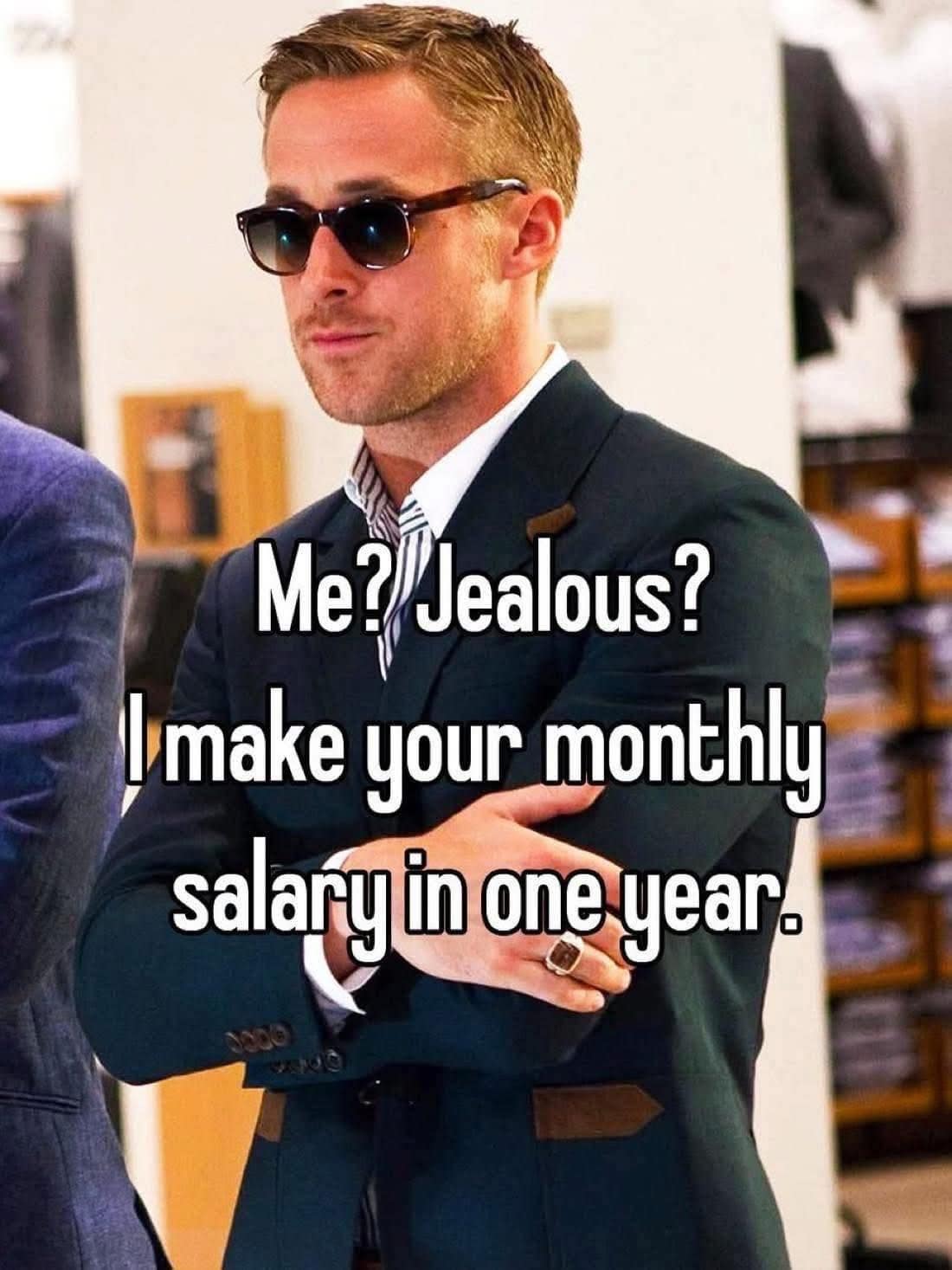 A funny pic of Ryan Gosling in a suit making a joke about monthly salary.