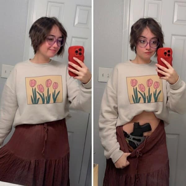 Girl in tulip sweater revealing handgun holstered under skirt.