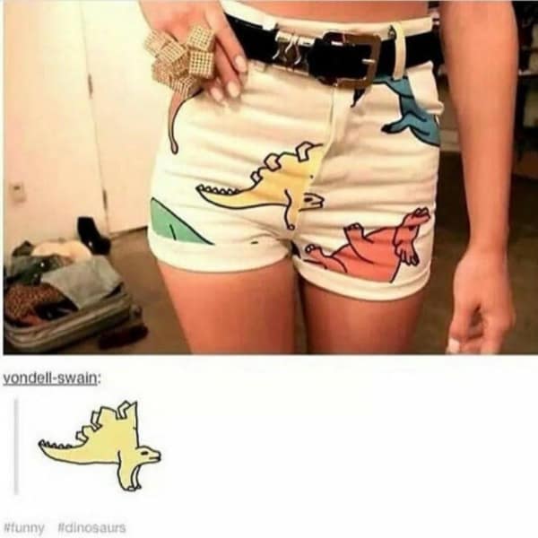 Pair of shorts with dinosaur pattern where the animals are printed upside down.