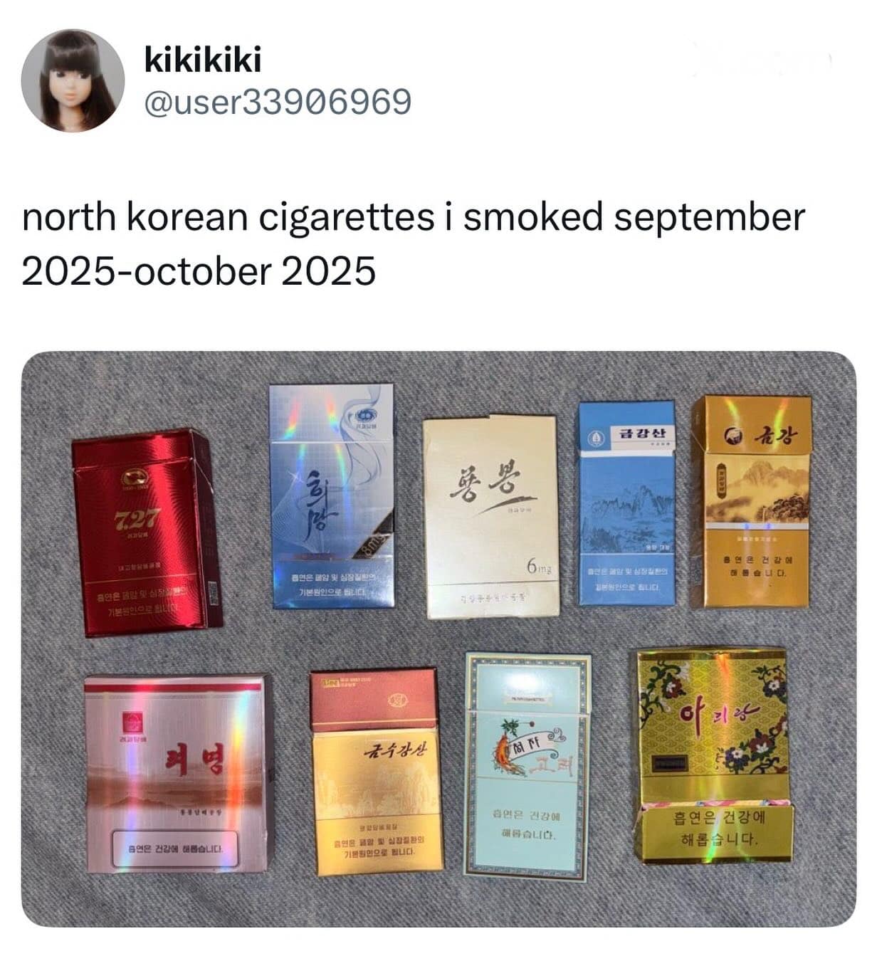 Collection of various colorful North Korean cigarette packs displayed on a gray surface.