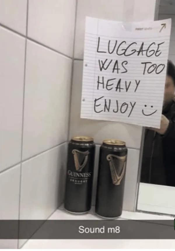 Note in a bathroom stall offering two free cans of Guinness because luggage was overweight.