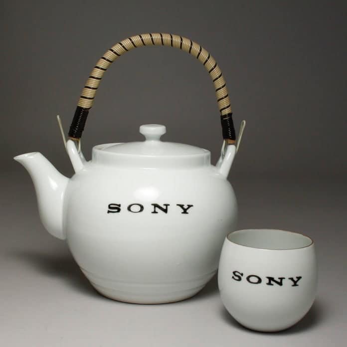 White porcelain teapot and matching cup with the word SONY printed in black.