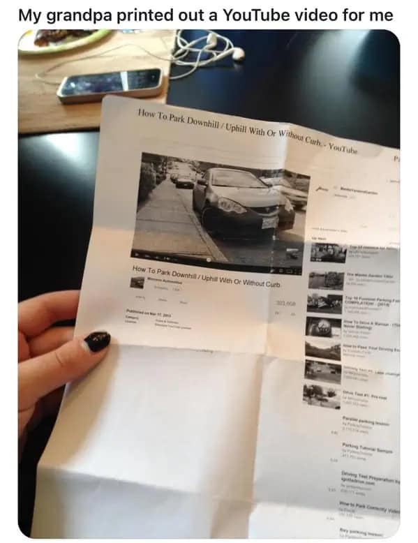 A hilarious meme photo of a grandpa who printed out a YouTube video on paper.