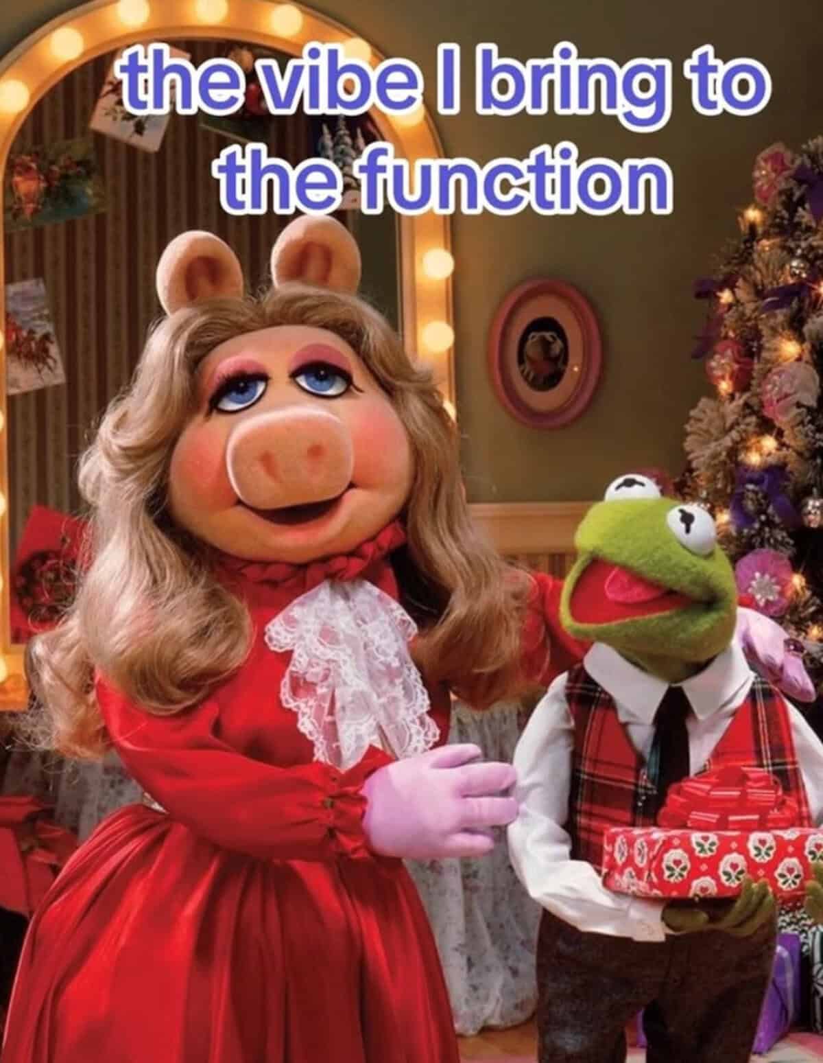 A Muppet Christmas Carol meme of Miss Piggy and Kermit dressed for the holidays.