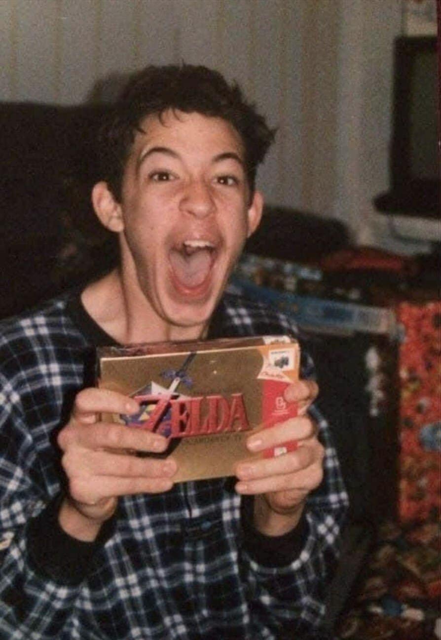 A retro christmas photo of a boy screaming over a Zelda game.
