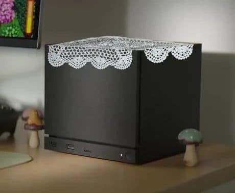 A black Valve Steam Machine meme box covered with a grandmother's doily.