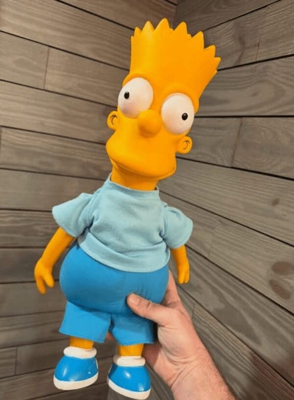 A vintage Bart Simpson doll with a plastic head and cloth body, a popular 90s toy.