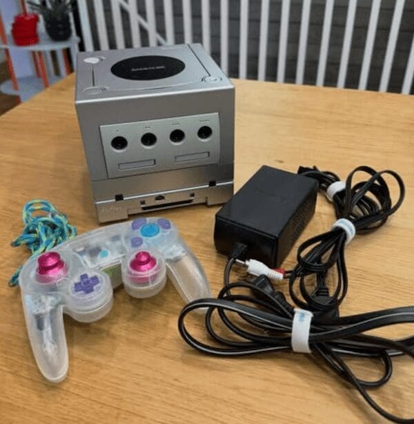A silver Nintendo GameCube console with a clear controller, a beloved retro toy gaming system