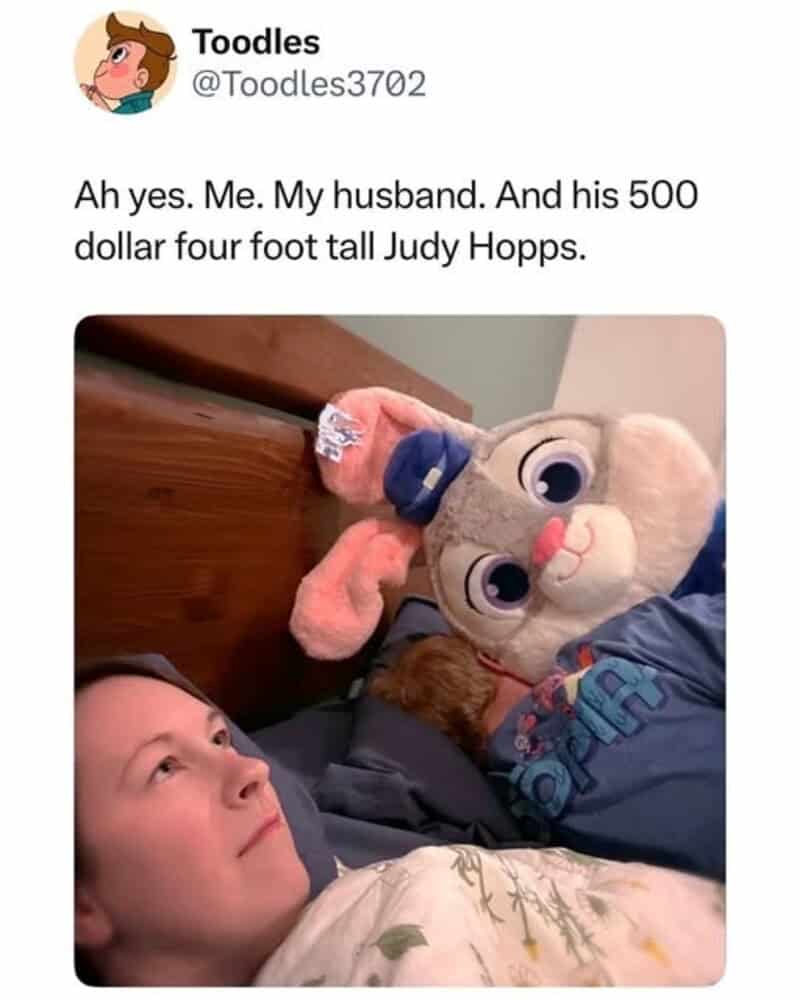 A Disney meme showing a woman looking tired in bed next to her husband and a massive Judy Hopps plush from Zootopia.