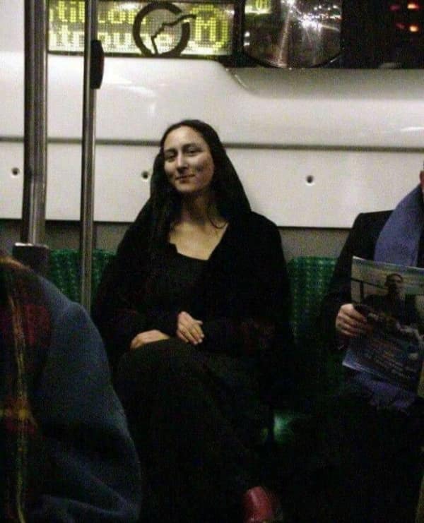 Woman on public transport with a smile resembling the Mona Lisa.