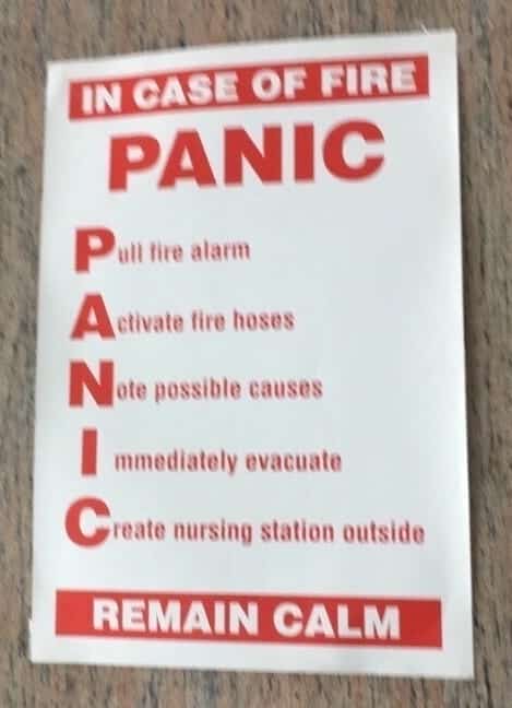 Safety sign using the acronym PANIC to list fire safety procedures and instructions.