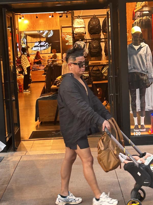 A photo of a man with a tall spiky bad haircut resembling a paintbrush or pineapple.