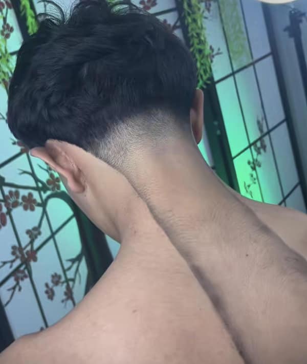 A bad haircut showing a shaved neckline with a long thin strip of hair left down the center.
