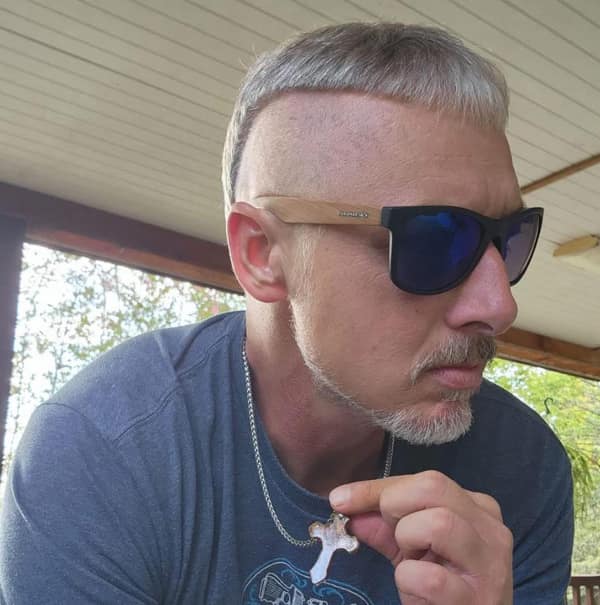 A man with a high fade and a very blunt short bowl cut on top bad haircut.