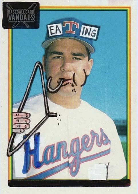 A baseball card vandals piece titled "Eating Hangers" showing a player with a wire hanger drawn into his mouth.