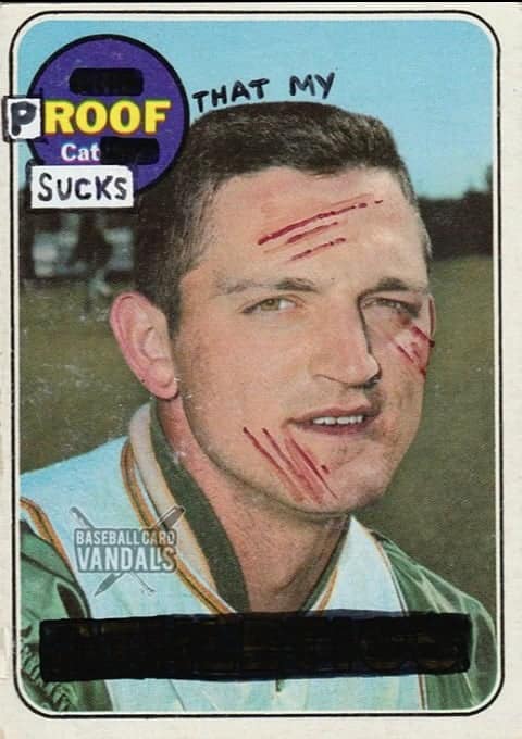 A baseball card vandals creation with red scratches on a player's face and text declaring "Proof that my cat sucks."