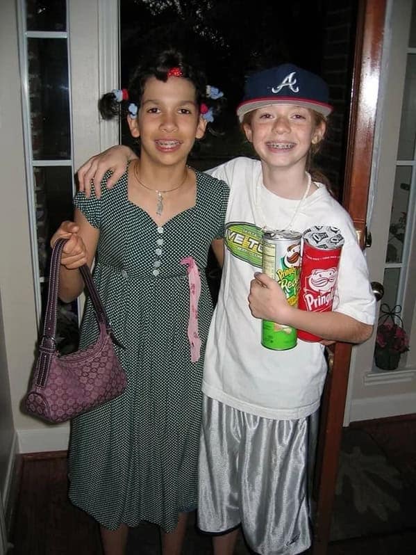 Two kids in awkward costumes holding Pringles cans blunder years.