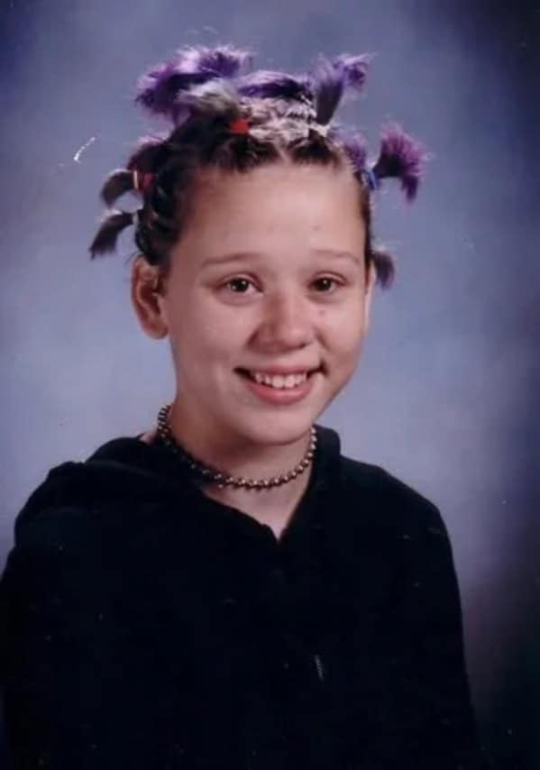 Girl with crazy Coolio style pigtails and choker blunder years.