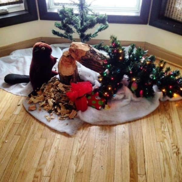 Christmas display featuring a stuffed beaver and logs chewed into stumps.